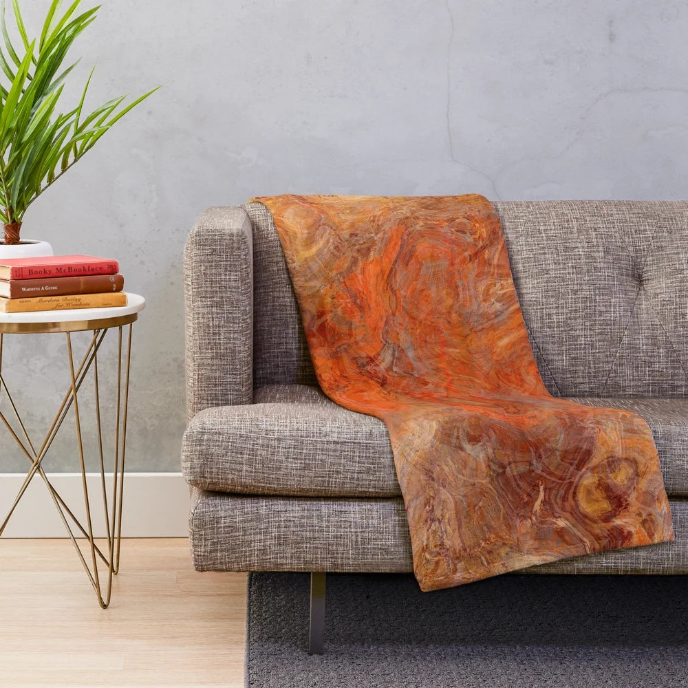 Gold and rust swirl pattern on a cozy plush blanket