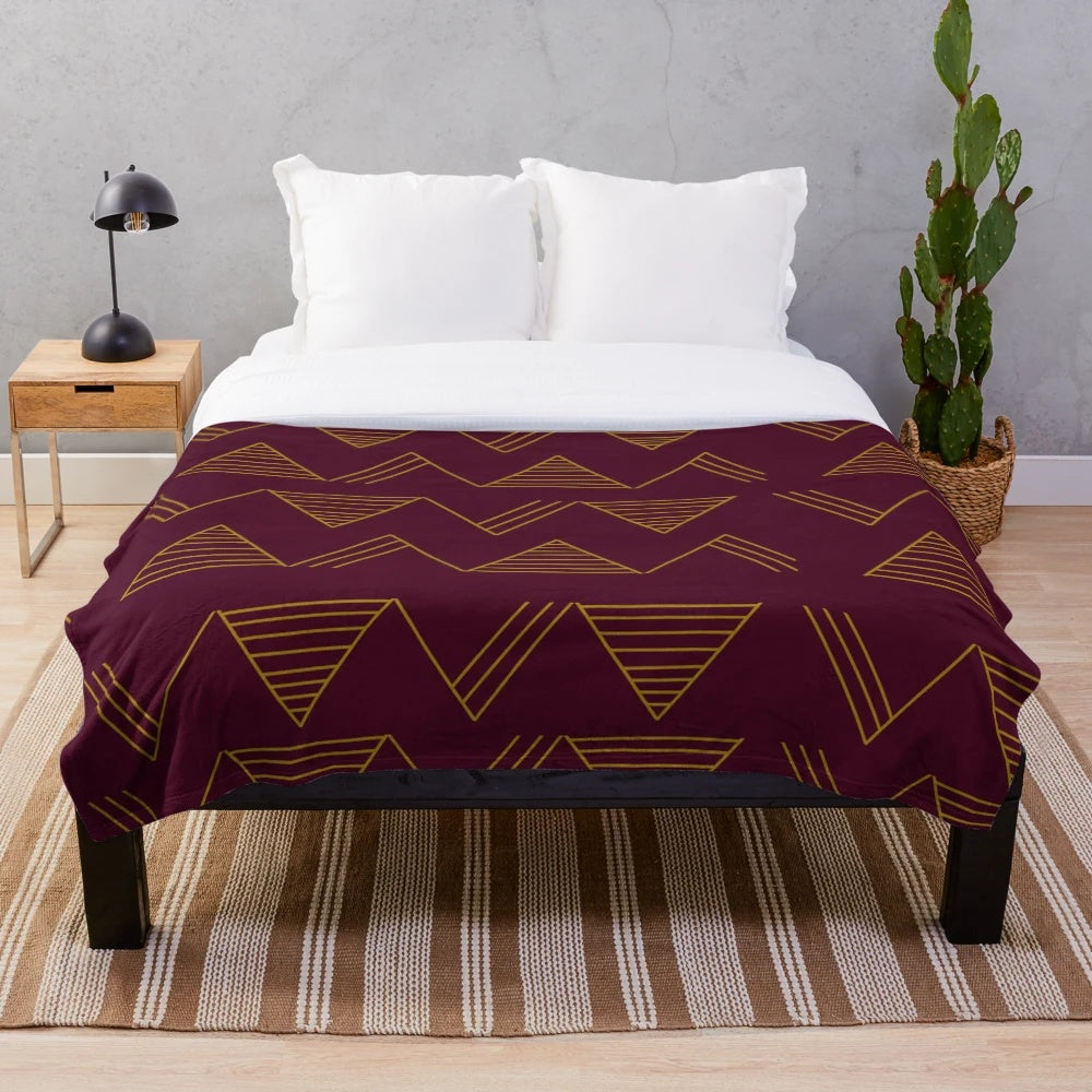 Soft, cozy plush blanket with a modern gold geometric pattern in jewel-toned colors