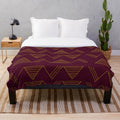 Soft, cozy plush blanket with a modern gold geometric pattern in jewel-toned colors