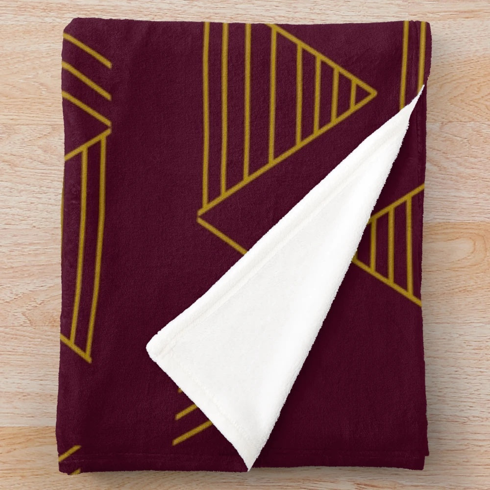Soft, cozy plush blanket with a modern gold geometric pattern in jewel-toned colors