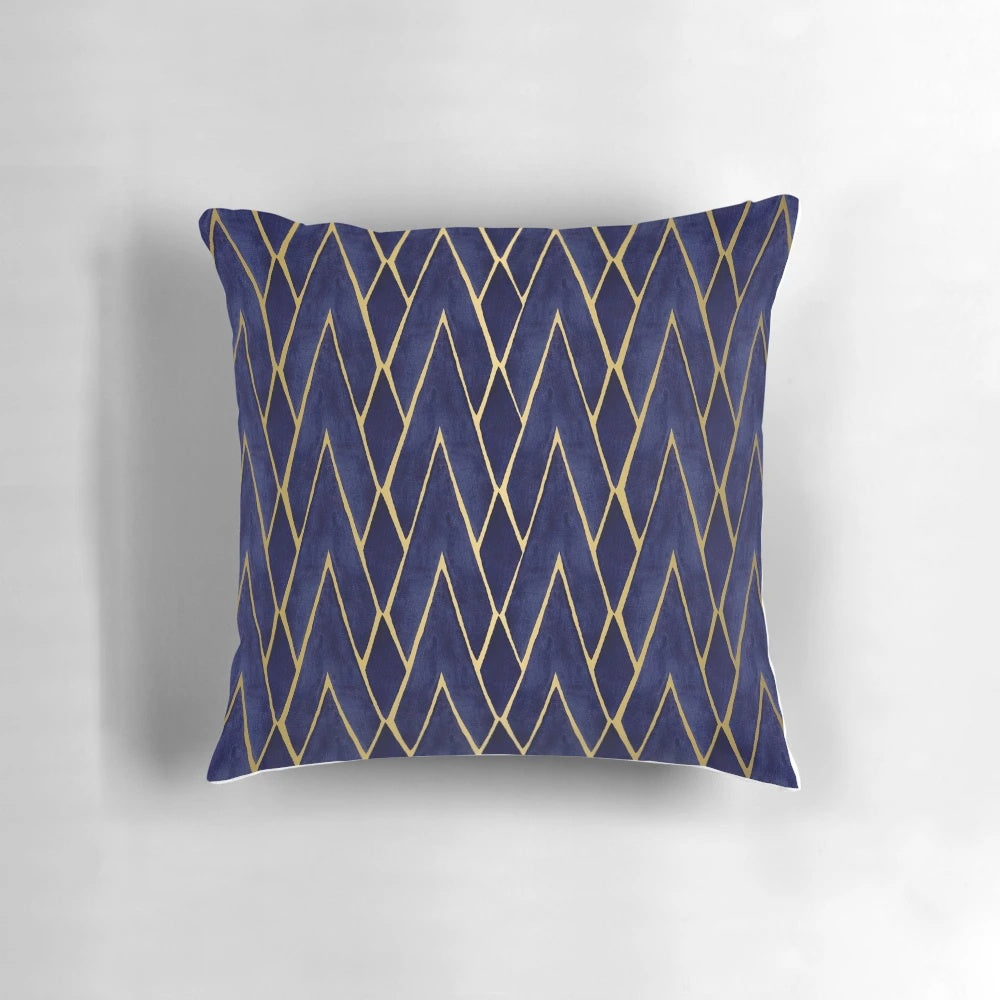 Indigo and gold art deco patterned throw pillow with diamond shapes and architectural design