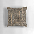 Closeup view of a leopard print pillow with a geometric pattern and a soft, plush faux fur texture.