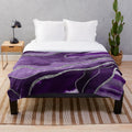 Plush blanket with abstract marble and agate design in shades of purple and silver glitter