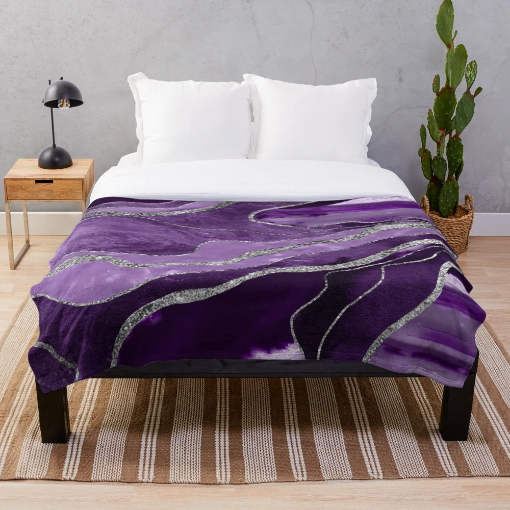 Plush blanket with abstract marble and agate design in shades of purple and silver glitter