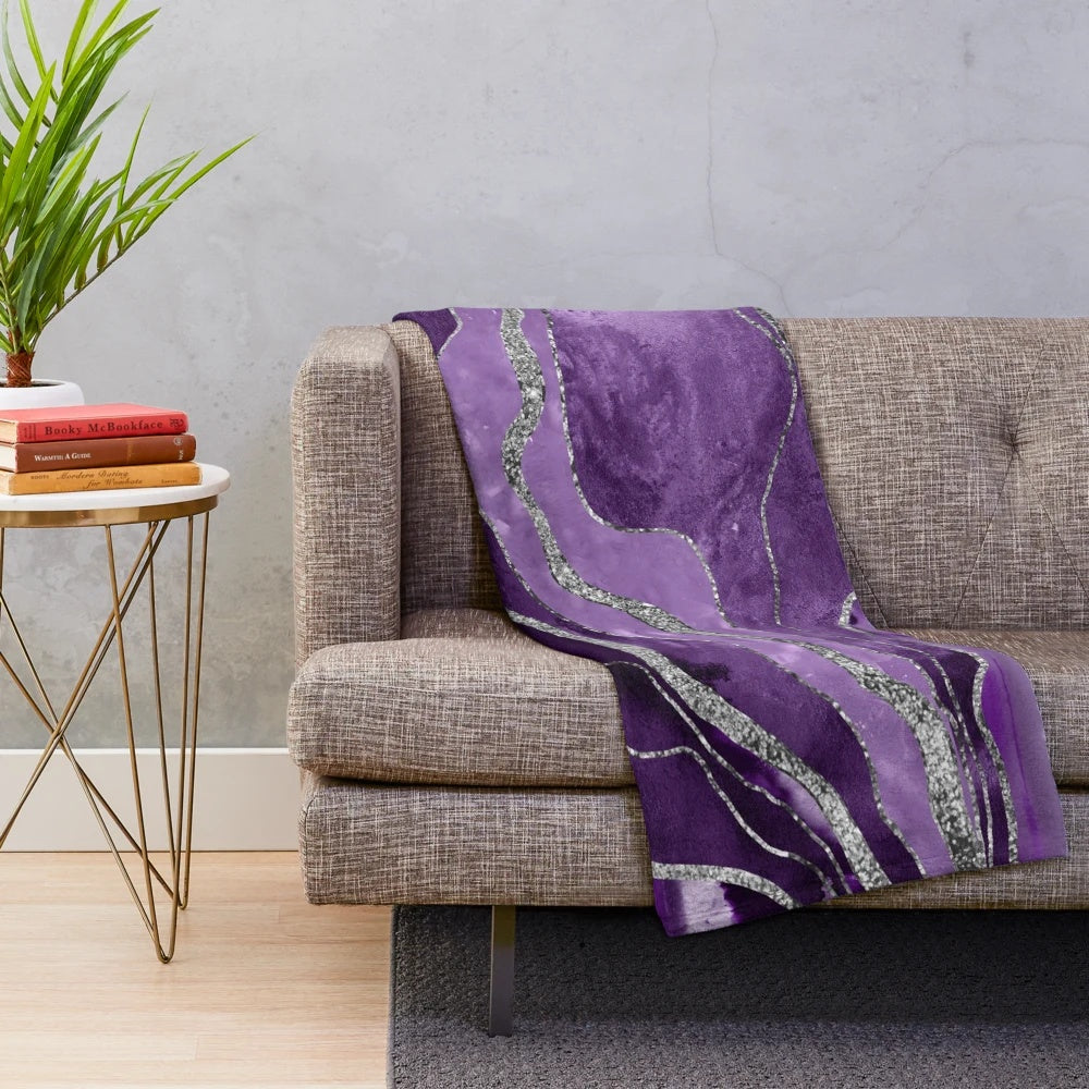 Plush blanket with abstract marble and agate design in shades of purple and silver glitter