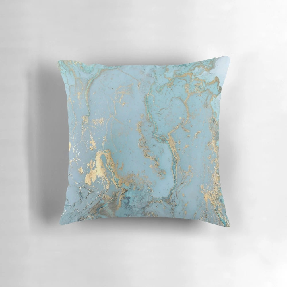 Marble-inspired decorative pillow with teal, gold, and geometric patterns
