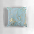 Marble-inspired decorative pillow with teal, gold, and geometric patterns