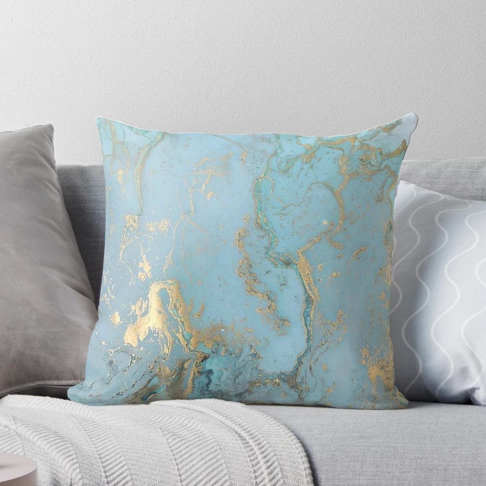 Marble-inspired decorative pillow with teal, gold, and geometric patterns