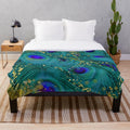 Plush blanket featuring a dreamy peacock feather design in teal, purple, and glimmering gold