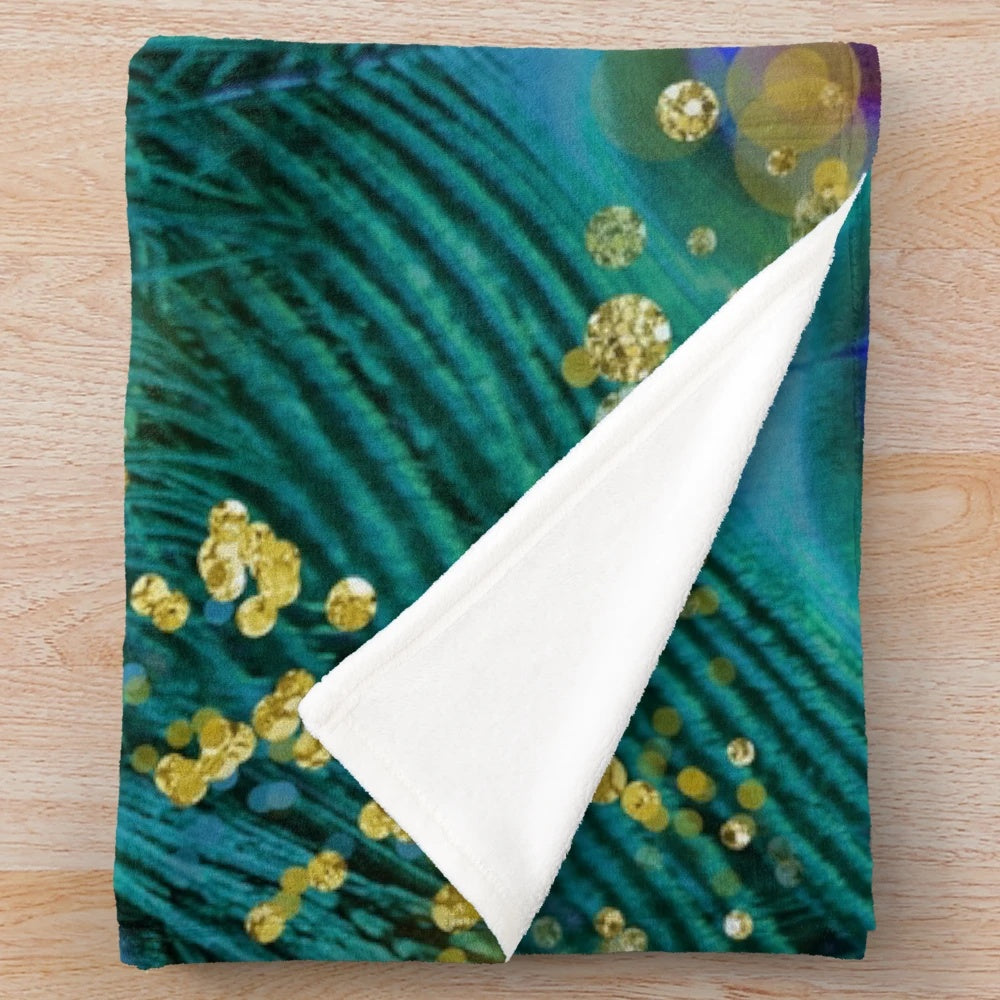Plush blanket featuring a dreamy peacock feather design in teal, purple, and glimmering gold