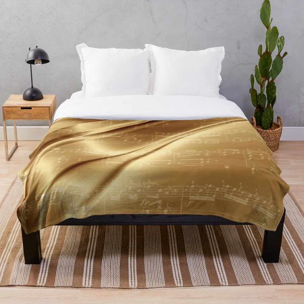 Plush blanket with music sheet design in liquid gold