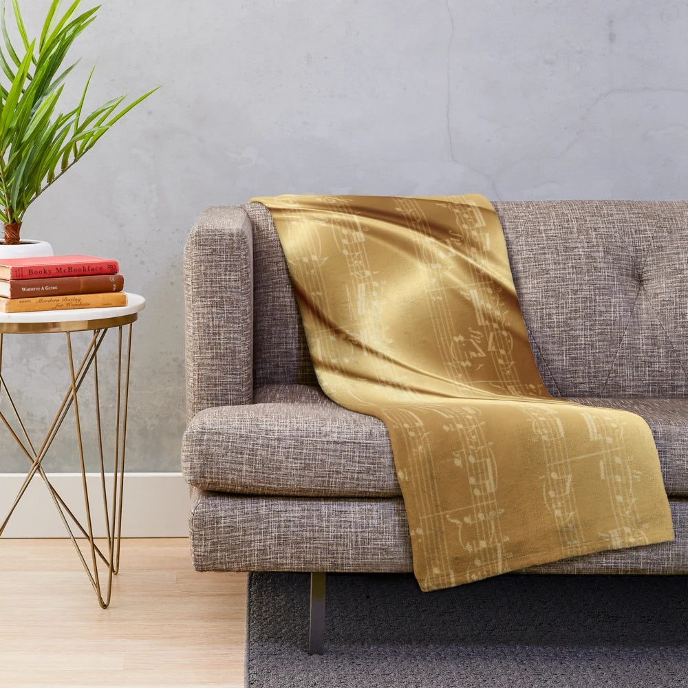 Plush blanket with music sheet design in liquid gold