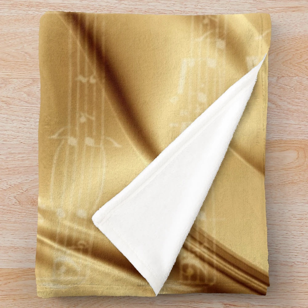 Plush blanket with music sheet design in liquid gold