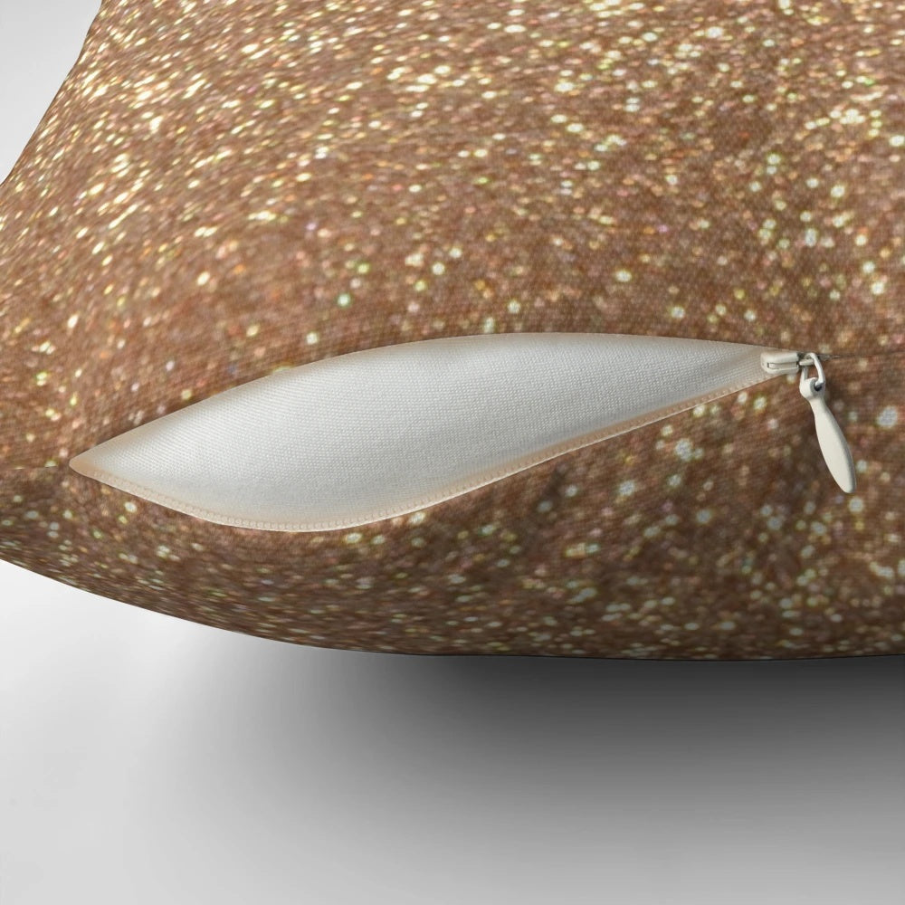Close-up of a soft, shimmering rose gold metallic pillow with a glittery finish.