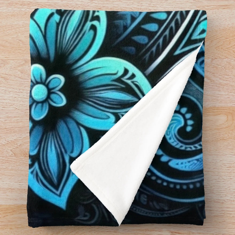Teal plush blanket with tropical floral and oceanic patterns
