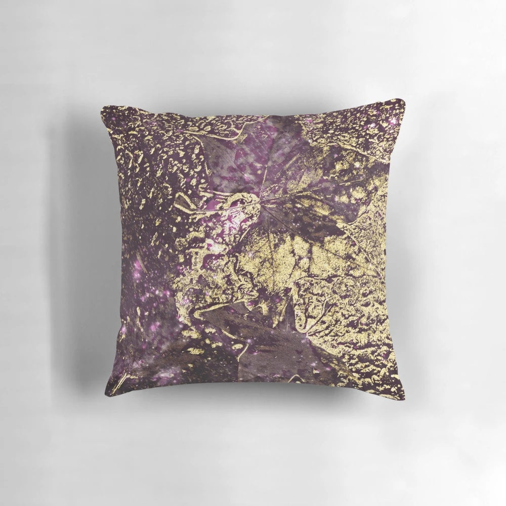 Luxury pillow featuring abstract design of purple and gold leaves