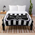Black and white striped plush blanket with a gothic, creepy aesthetic