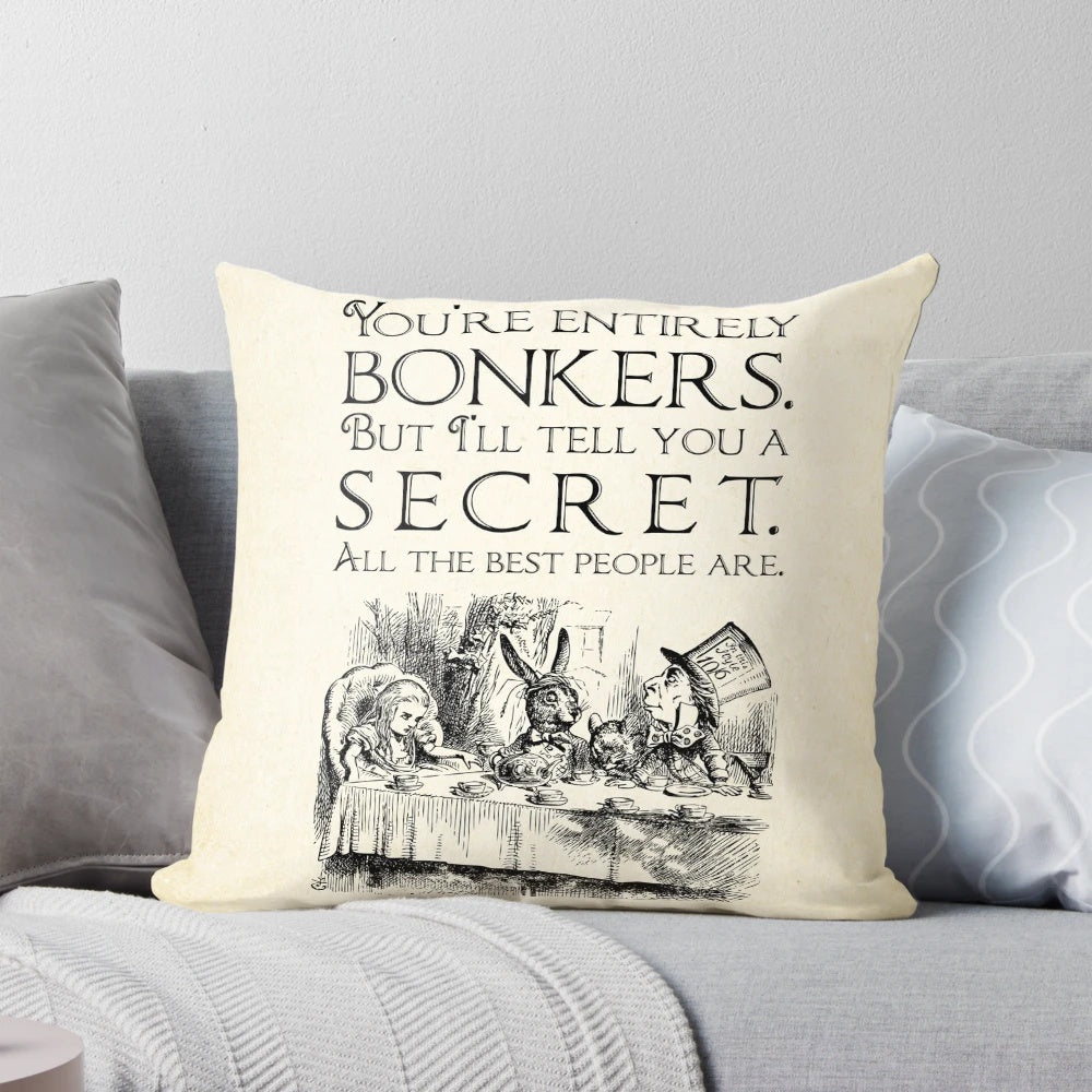 Decorative throw pillow featuring the quote "You're entirely bonkers" from the Mad Hatter in Alice in Wonderland.