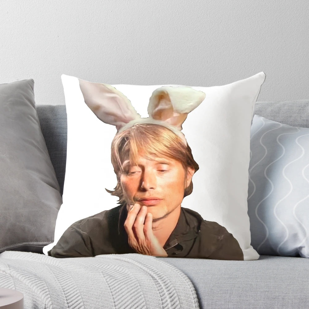 Mads Mikkelsen as Hannibal Lecter with bunny ears on a stylish pillow