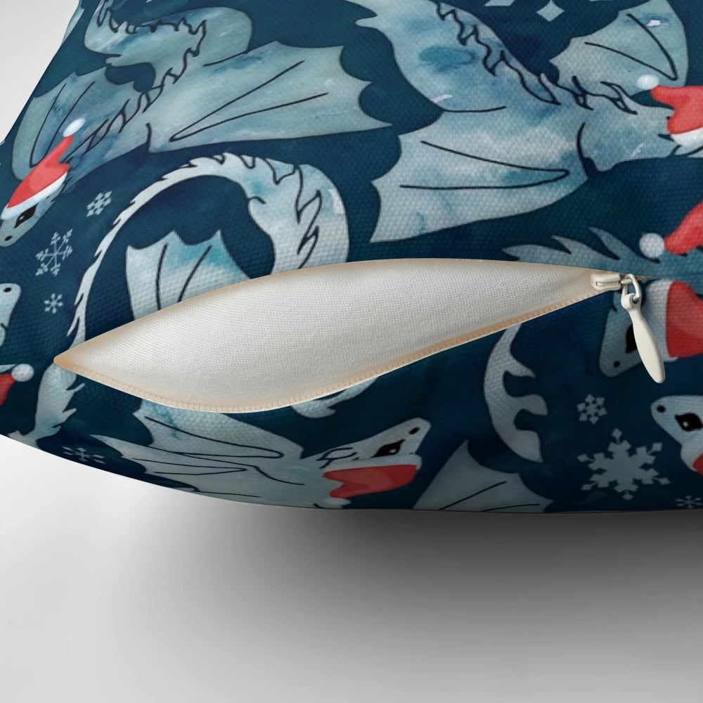 A blue decorative pillow featuring a whimsical dragon surrounded by a watercolor snowflake design, perfect for holiday and winter décor.