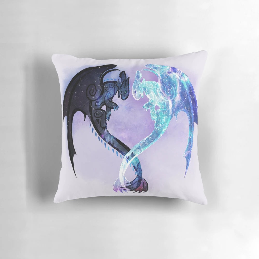 A decorative pillow featuring the dragon characters Toothless and Light Fury from the How to Train Your Dragon fantasy film series.