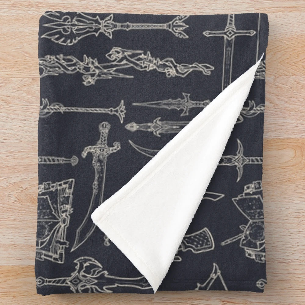 Plush blanket featuring illustrated fantasy weapons like swords, daggers, and wands for tabletop RPG enthusiasts.