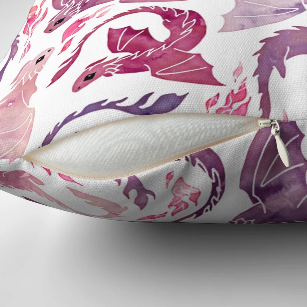 A decorative throw pillow featuring a whimsical, fire-breathing dragon in shades of pink and purple watercolor.