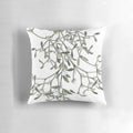 Soft white pillow with green mistletoe print, perfect for Christmas and winter decor