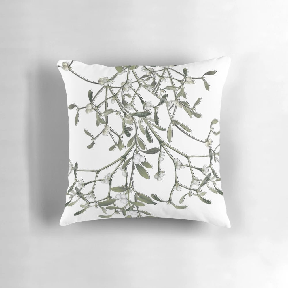 Soft white pillow with green mistletoe print, perfect for Christmas and winter decor