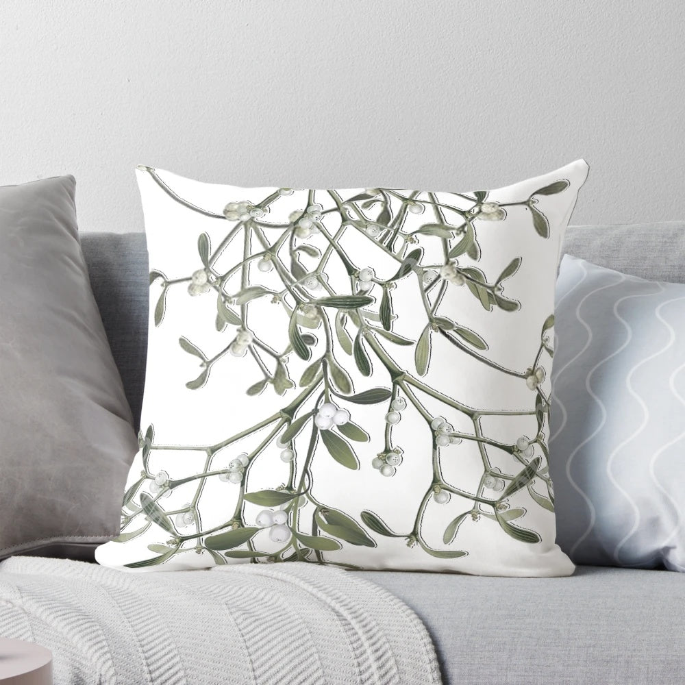 Soft white pillow with green mistletoe print, perfect for Christmas and winter decor