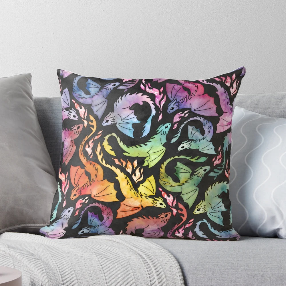 Watercolor illustration of a cute, fire-breathing dragon on a dark background with a vibrant rainbow.