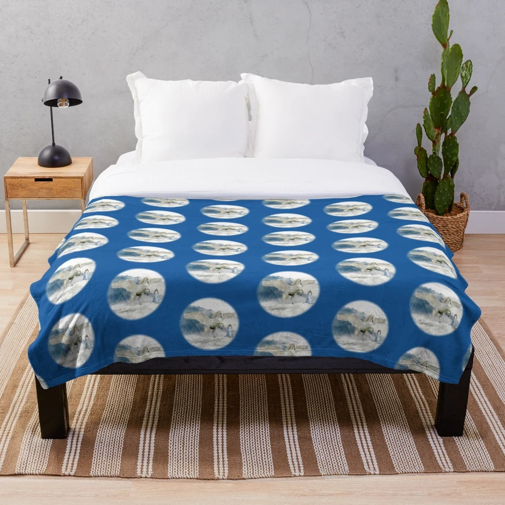 Plush blanket featuring a white unicorn and pegasus in a snowy, fantasy landscape