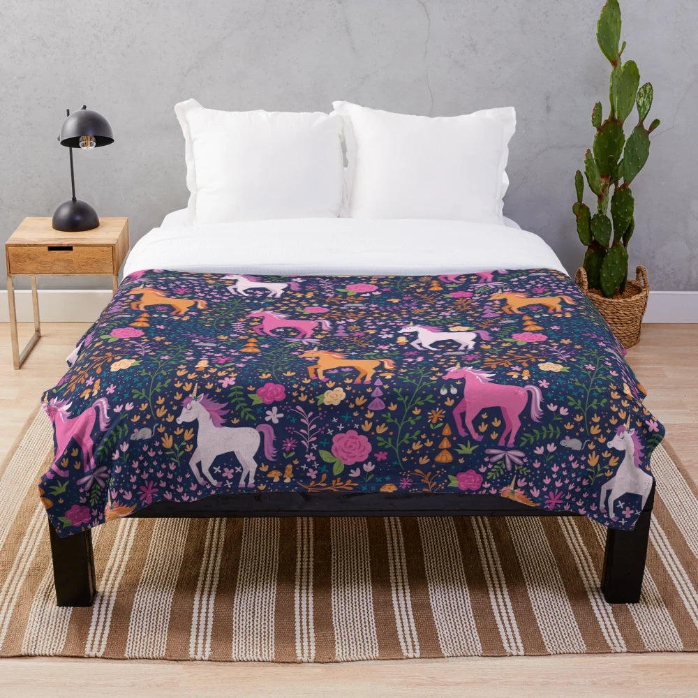 Soft and cozy plush blanket with a whimsical unicorn and floral design