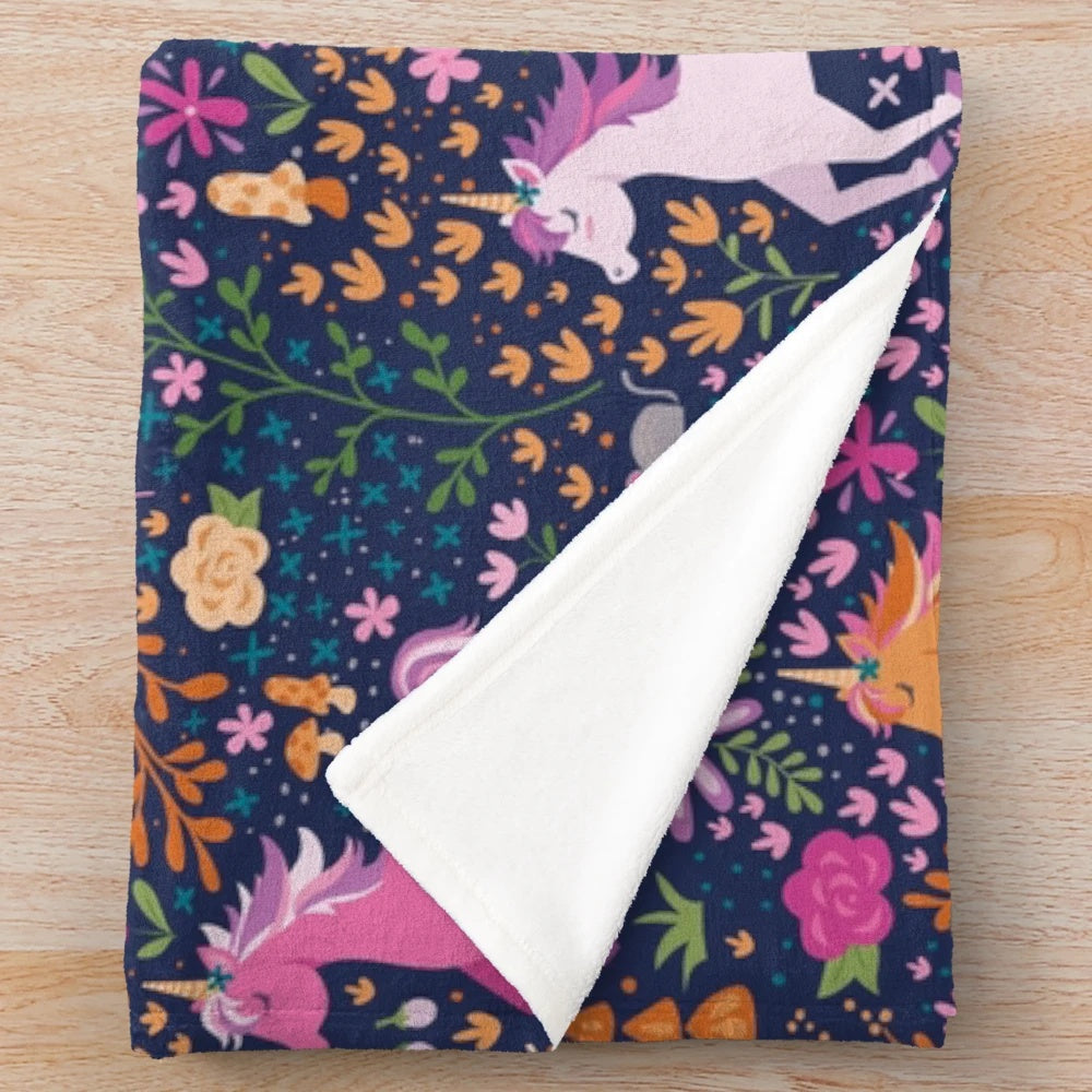 Soft and cozy plush blanket with a whimsical unicorn and floral design