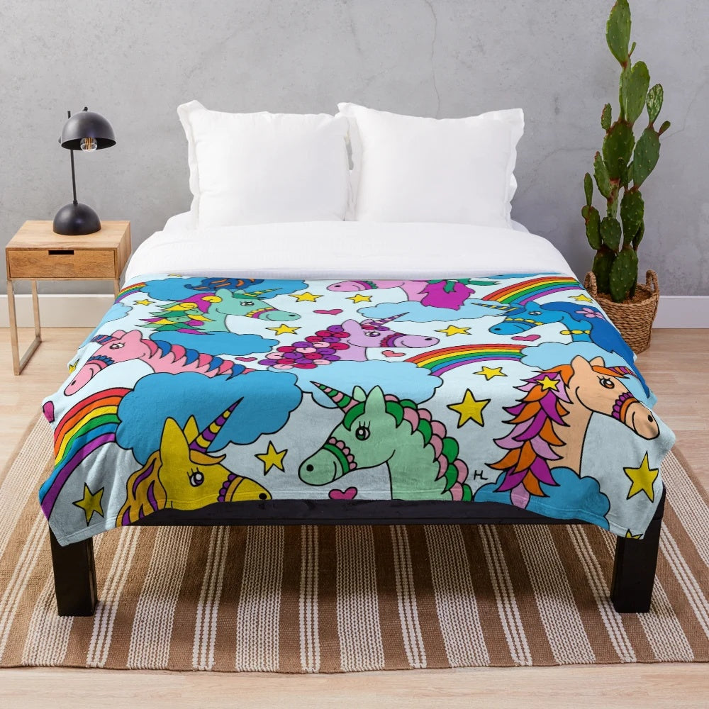 Colorful unicorn plush blanket with clouds and rainbows