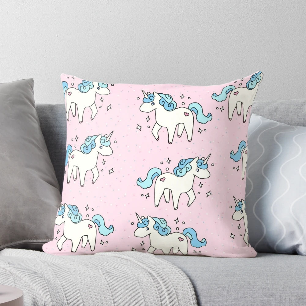 Soft, plush unicorn pattern pillow in pastel colors with a scattered design.