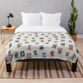 Mahjong-inspired plush blanket featuring mahjong tile patterns and designs