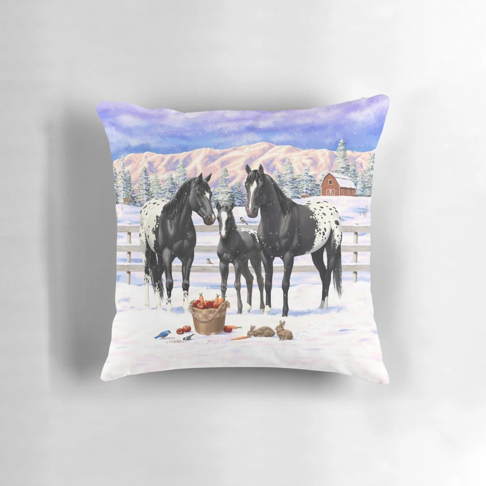 A Pillow featuring a beautiful black Appaloosa horse family in a snowy winter scene.