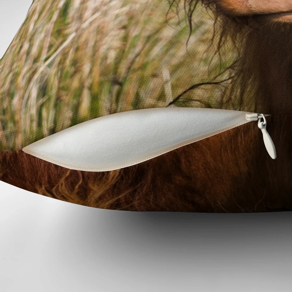 Soft, cozy pillow featuring a detailed portrait of a ginger highland cow in the lush, rolling hills of Cumbria, UK.