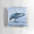 A pillow featuring a realistic image of a humpback whale breaching the ocean surface