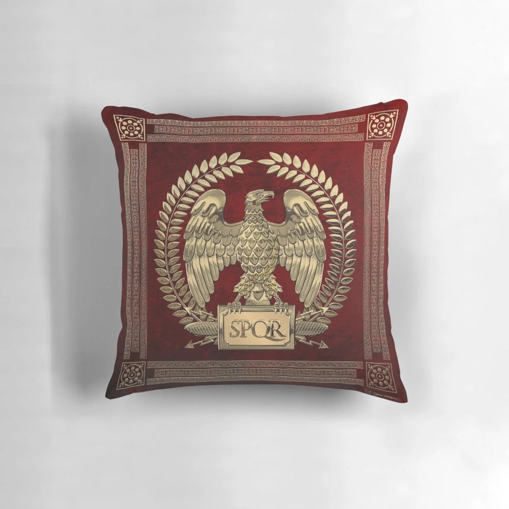 Photograph of a decorative pillow featuring a gold imperial eagle design on red velvet background