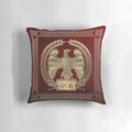 Photograph of a decorative pillow featuring a gold imperial eagle design on red velvet background