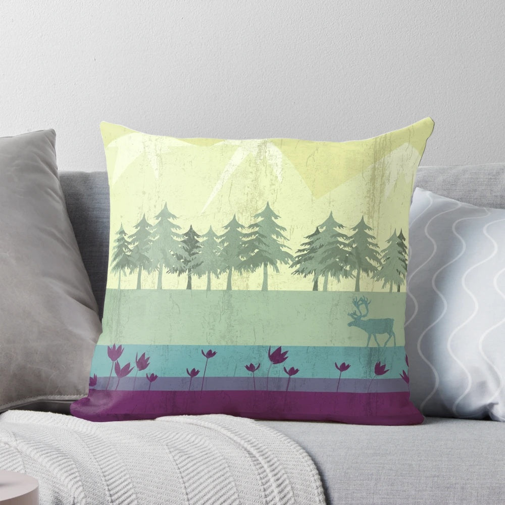 A vibrant, nature-inspired pillow featuring a deer against a backdrop of forests, mountains, and a gradient of colors