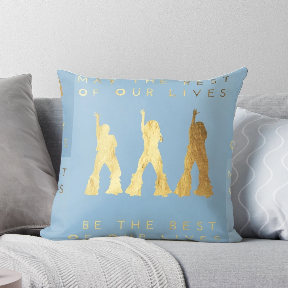 A golden foil-accented pillow featuring the iconic characters from the Mamma Mia musical and films.