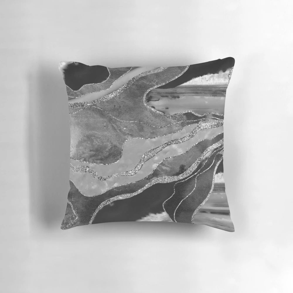 A decorative gray, black, and white marble agate silver glam pillow featuring a non-reflective glitter design.