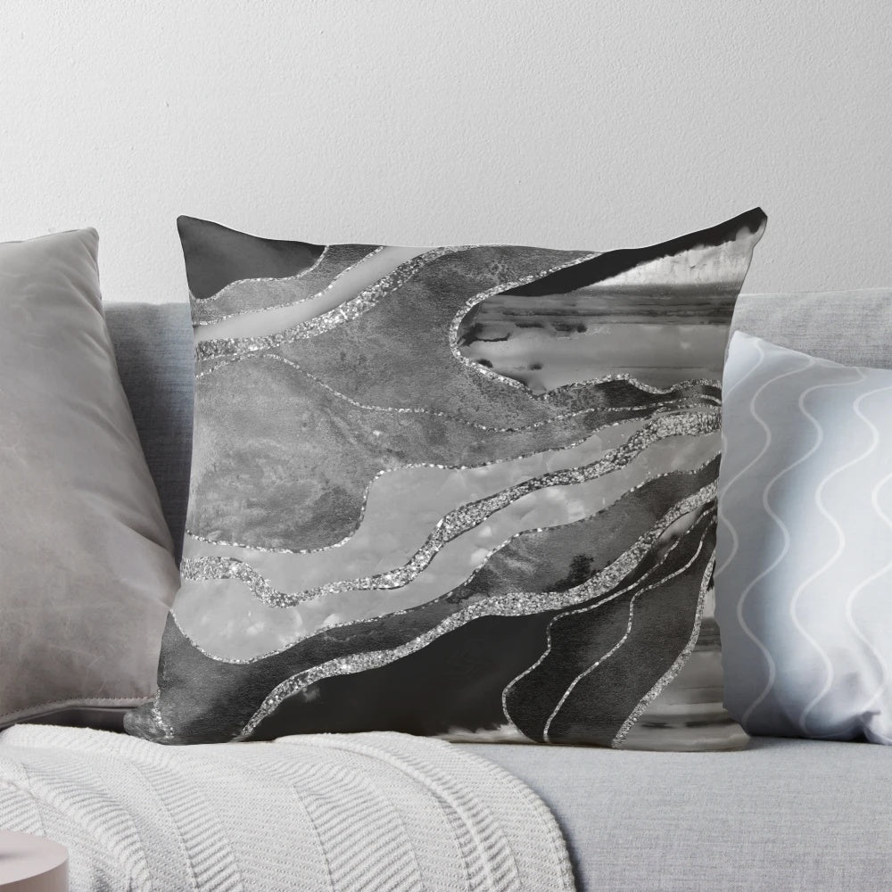 A decorative gray, black, and white marble agate silver glam pillow featuring a non-reflective glitter design.