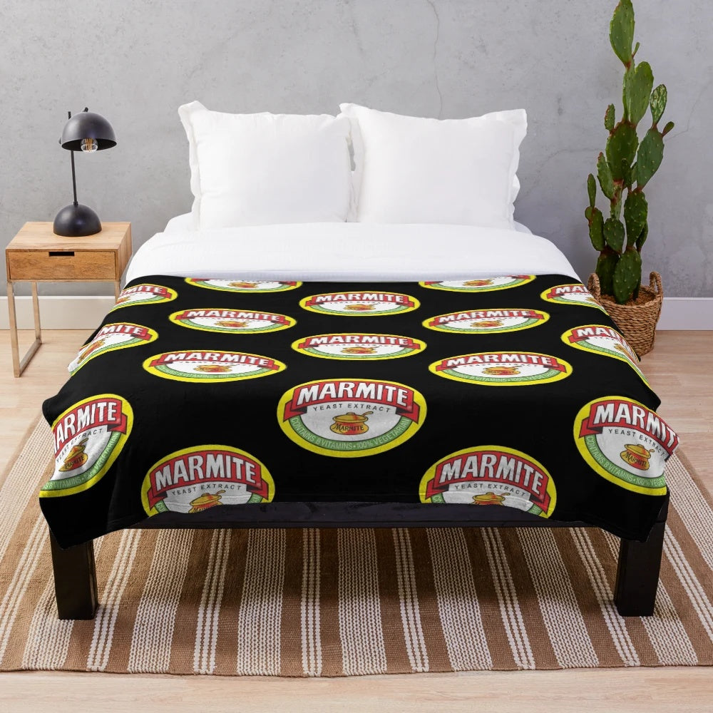 Marmite logos plush blanket, featuring the iconic Marmite logo design