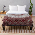 Maroon plush blanket with sindhi ajrak inspired floral pattern