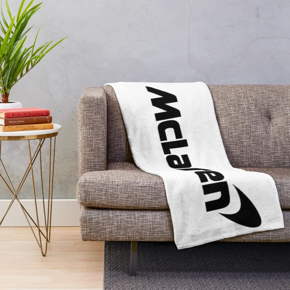 Mclaren F1 plush blanket featuring the F1 team's colors and logo