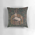 A decorative throw pillow featuring a magical unicorn in a medieval, renaissance-style floral landscape.